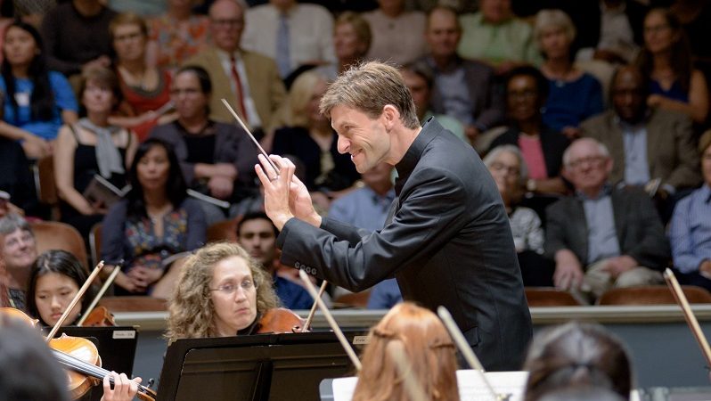 an image of Benjamin Rous conducting the Charlottesville symphony