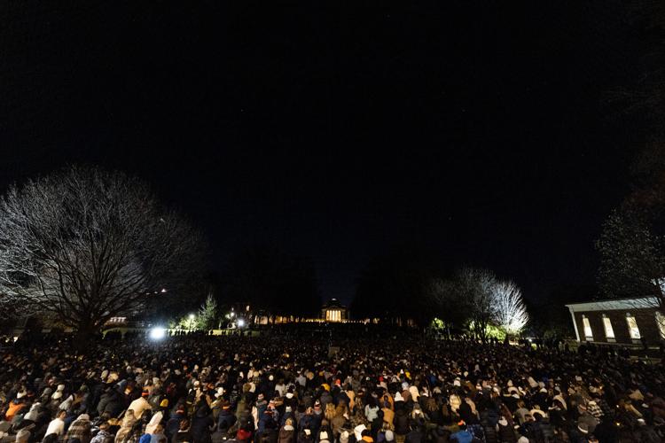 UVA students stand under three twinkling stars at a vigil on the lawn