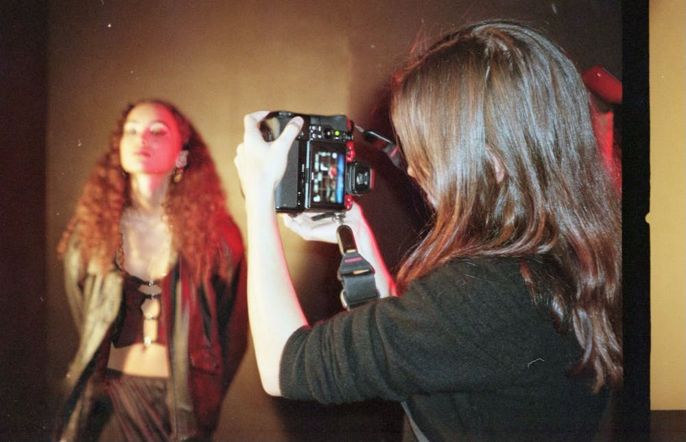 An image of someone photographing a model