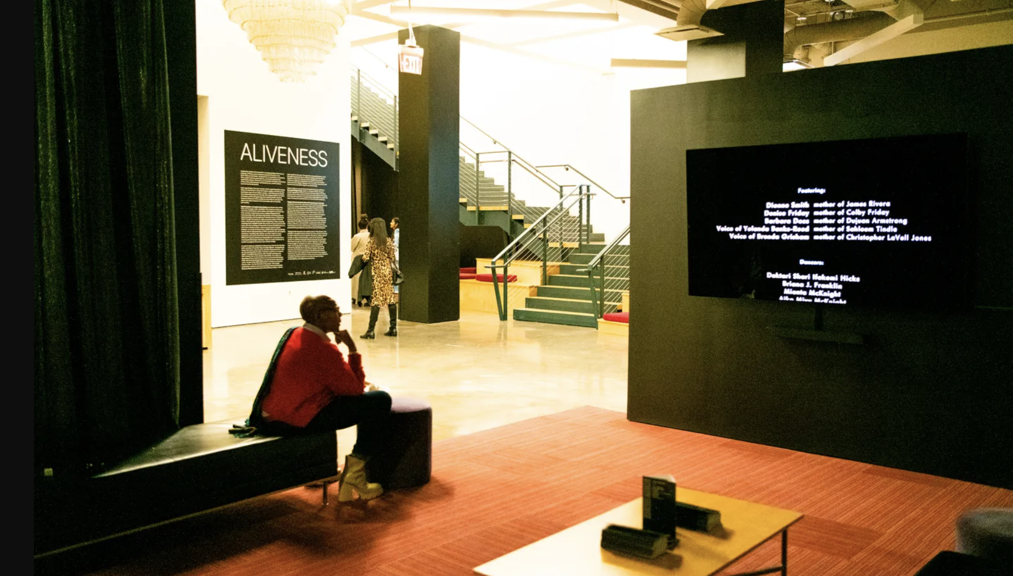 An image of someone watching a film at an exhibit