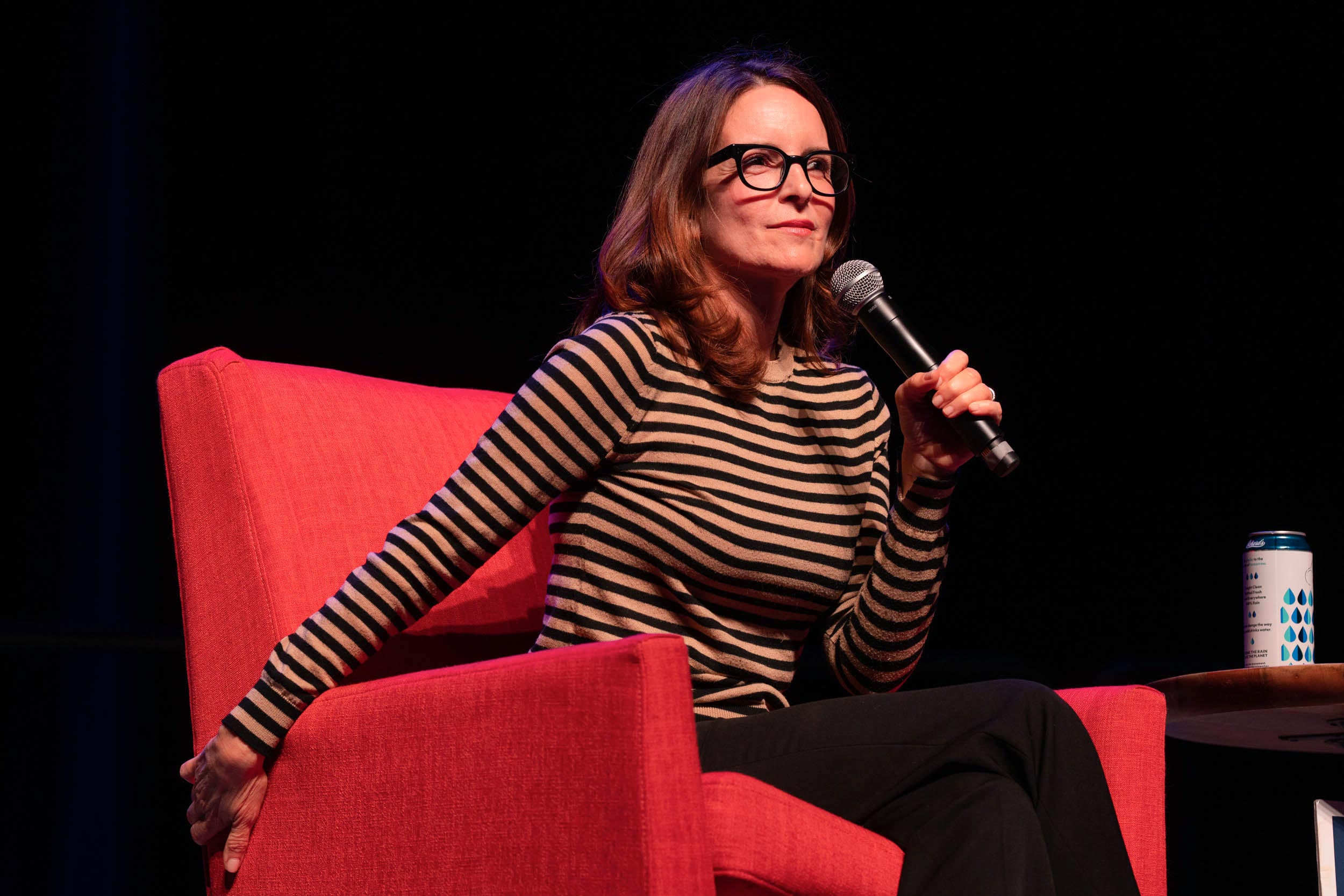 an image of Tina Fey sitting in a red chair