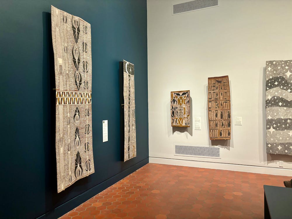 Five traditional Yolngu bark paintings hang on the white-and-teal walls of the Fralin museum.