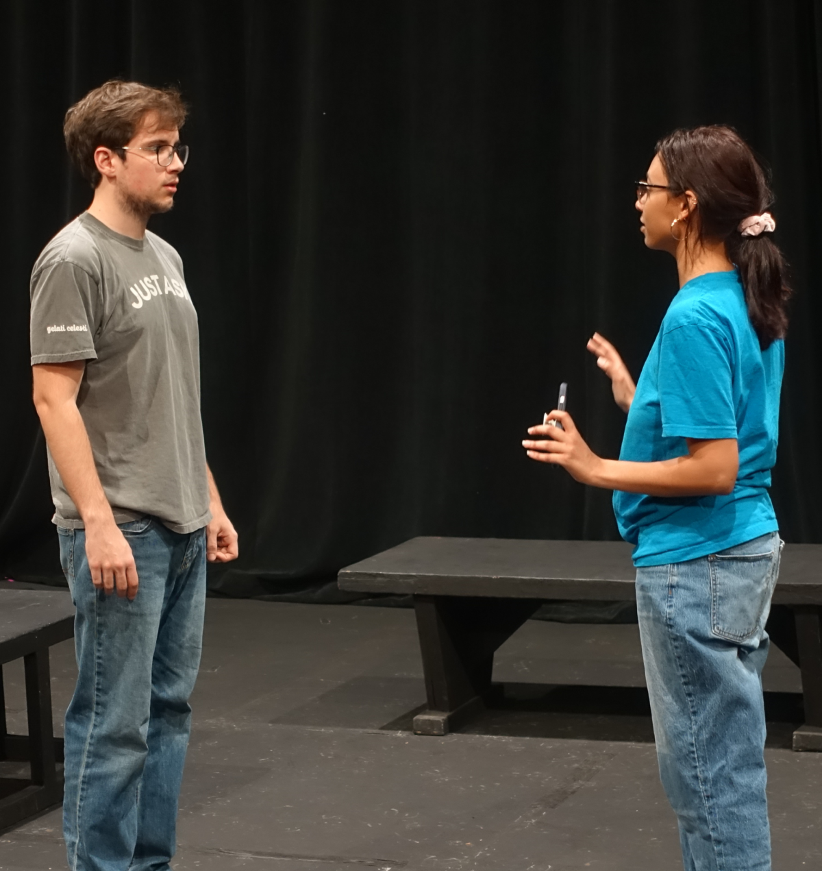 Cai Luzak looks at playwright Mary Low as she gives him instructions onstage in the Helms Theatre. 