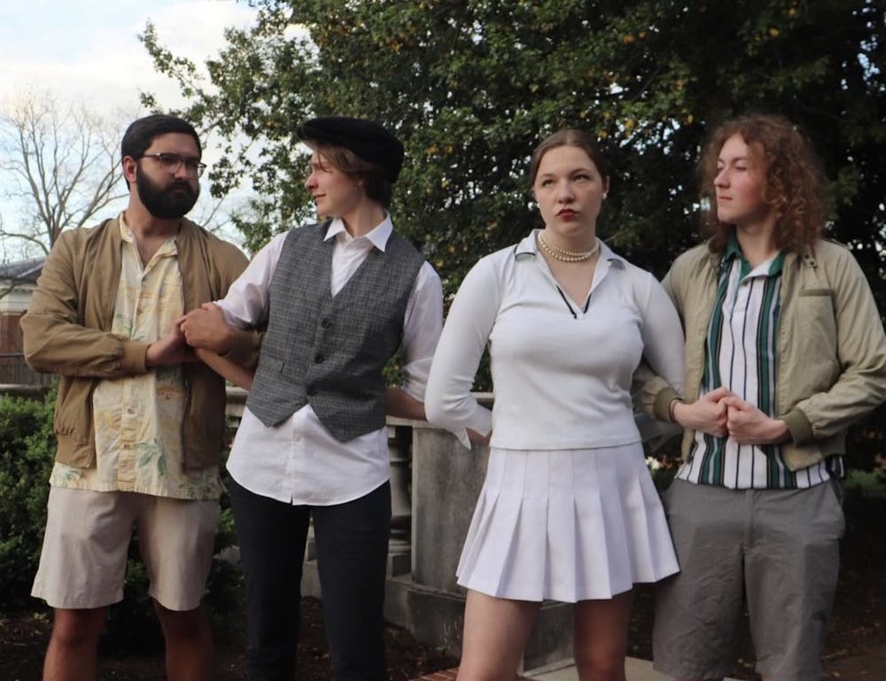 Four cast members of Shakespeare on the Lawn's "Much Ado About Nothing" pose in costume for a photo outdoors.