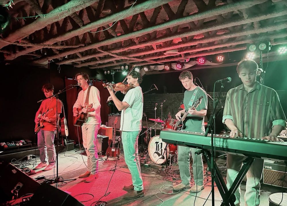 Boscobel, a band featuring five members, stands with instruments on the stage at the Southern under colorful lights.