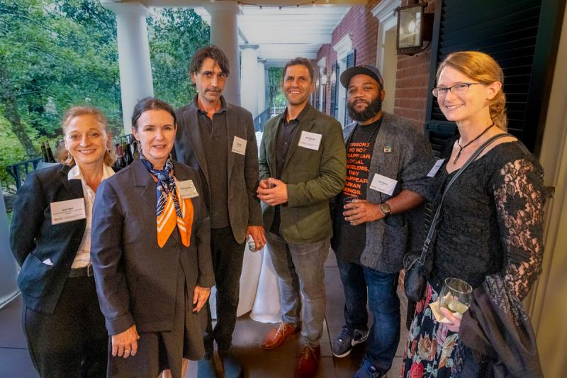 Six faculty members pose in front of the Colonnade Club.