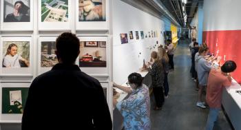 Left: Person looking at artwork hanging on a wall RIGHT: Hallway lined with folks making art
