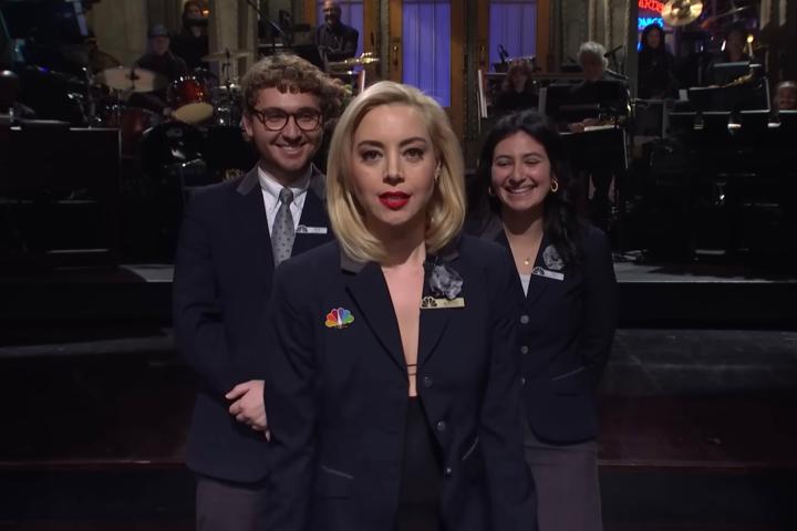 Micah Rucci and Aubrey Plaza on stage at SNL UVA graduate and NBC page Micah Rucci, left, appeared on camera during “The White Lotus” star Aubrey Plaza’s monologue on “Saturday Night Live.” (Photo courtesy of “Saturday Night Live”)