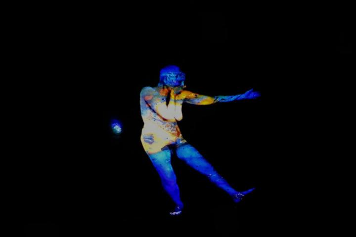 A blue and yellow human figure against a black background.