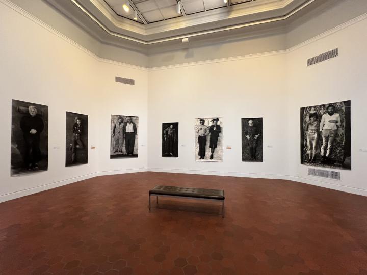 A wide shot of the Fralin gallery, the walls occupied by seven black and white photos from Holly Wright's series.